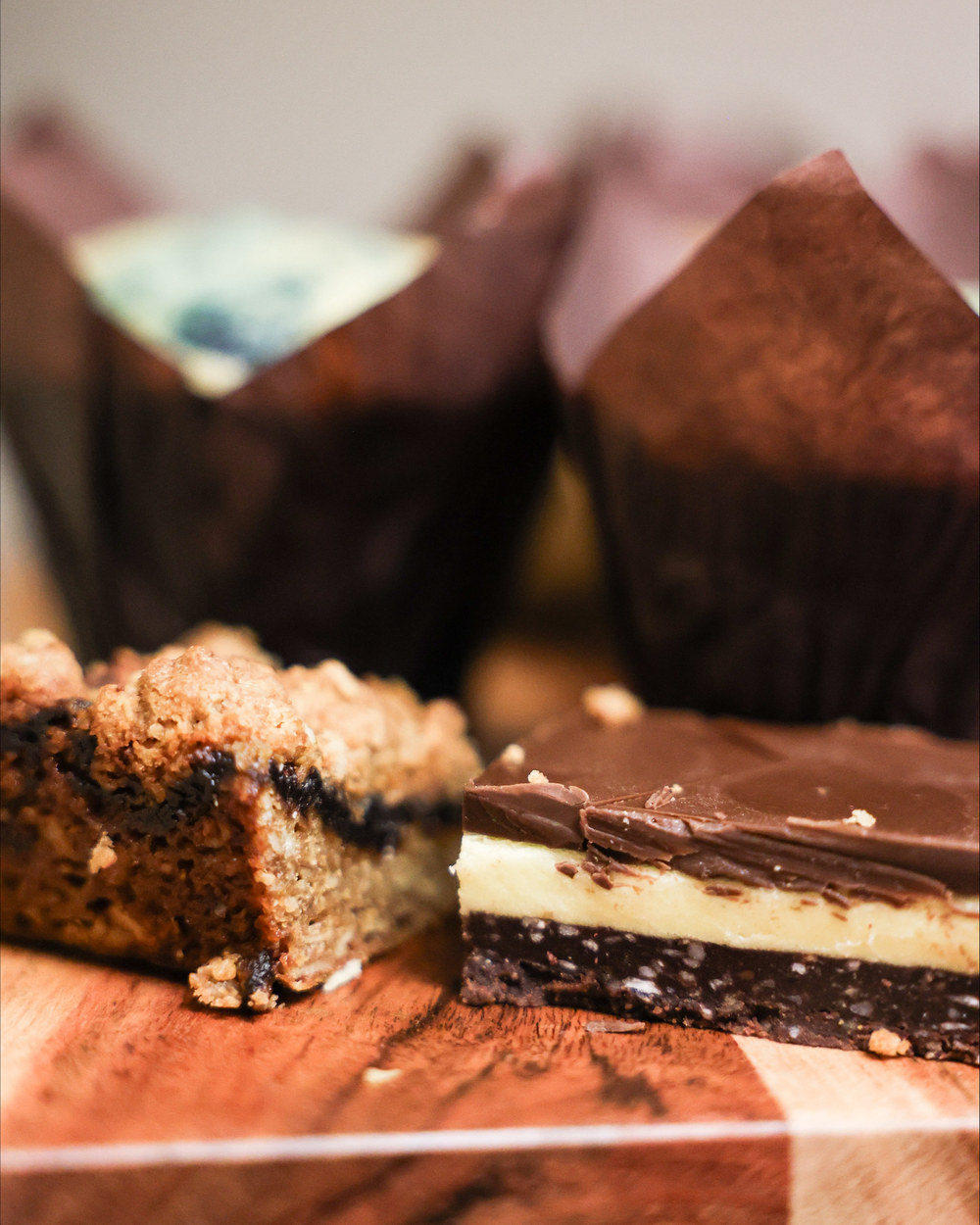 Muffins, Nanaimo bars and squares on a board
