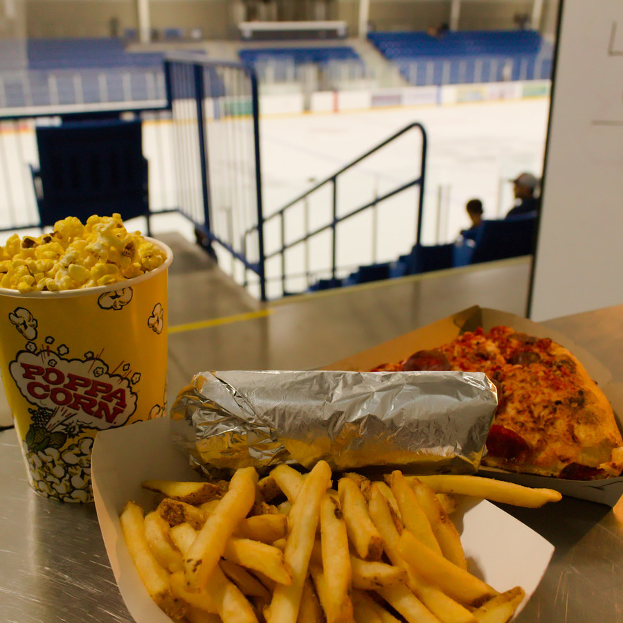 Popcorn, fries and pizza with the rink behind