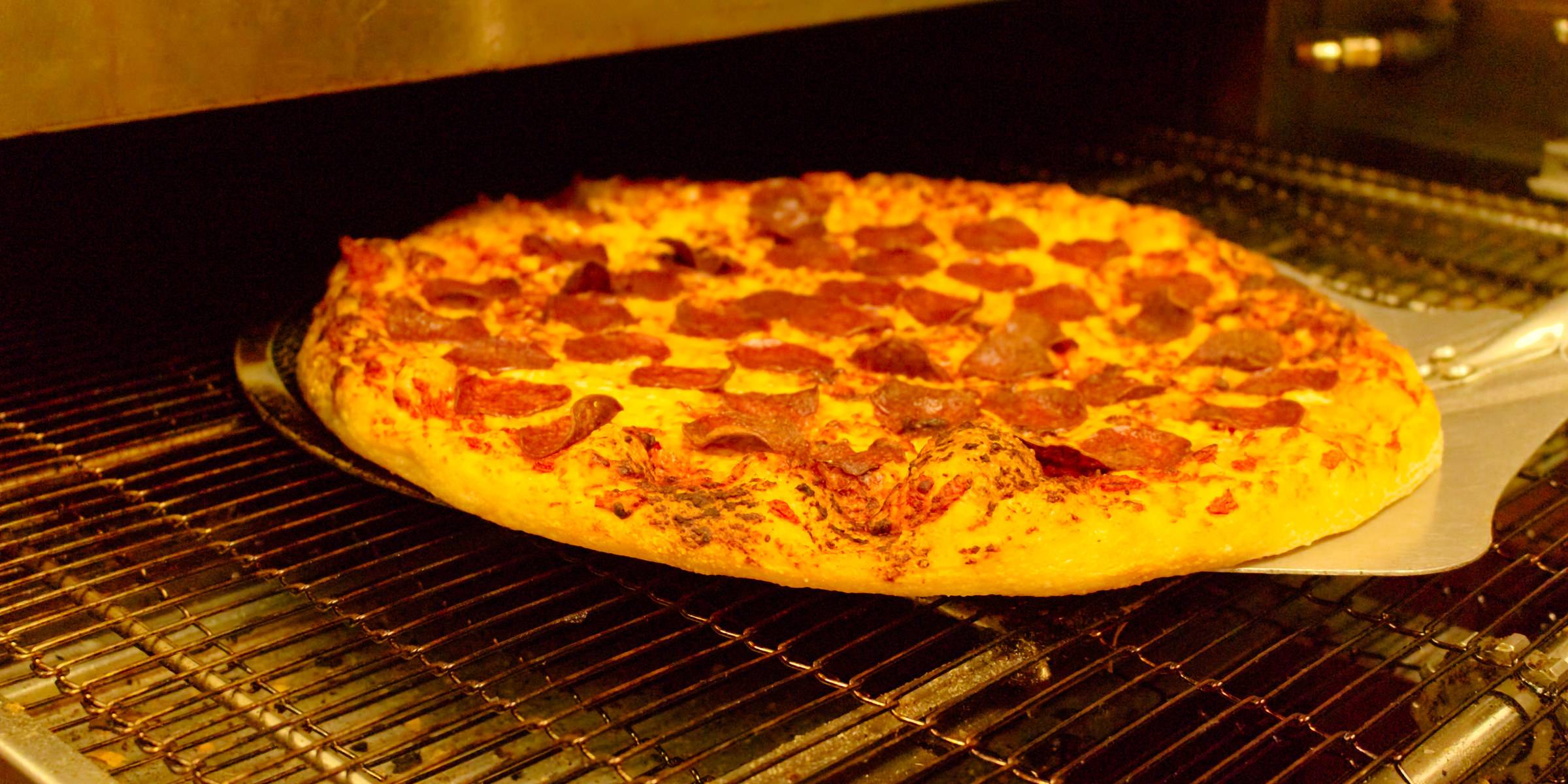 A pizza coming out of the oven at Puckz Pub