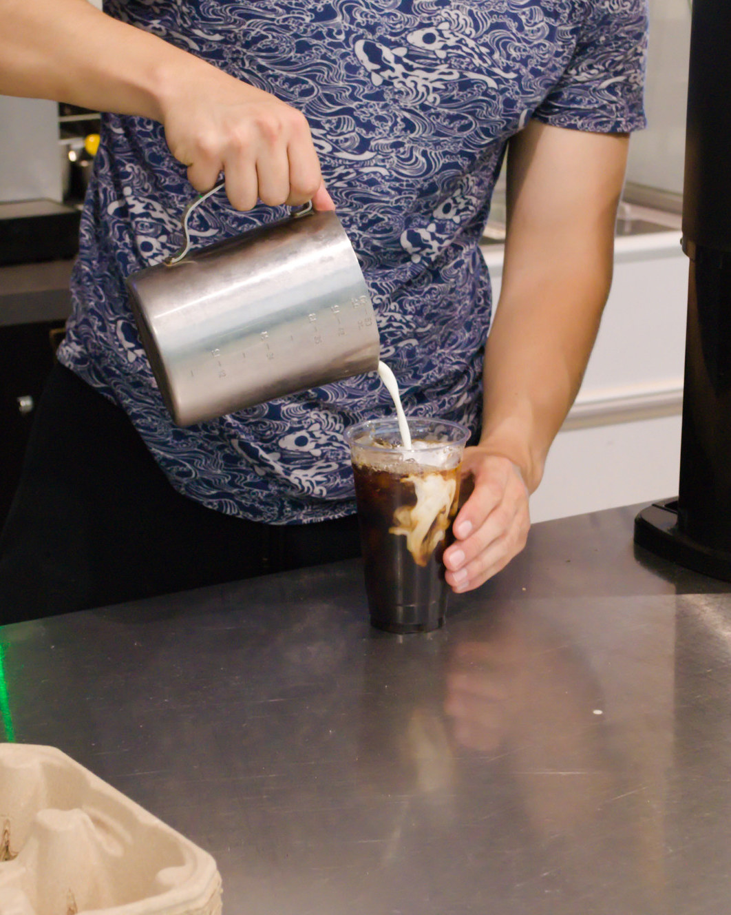 An iced coffee being poured to order at On the Fly Caf&eacute;